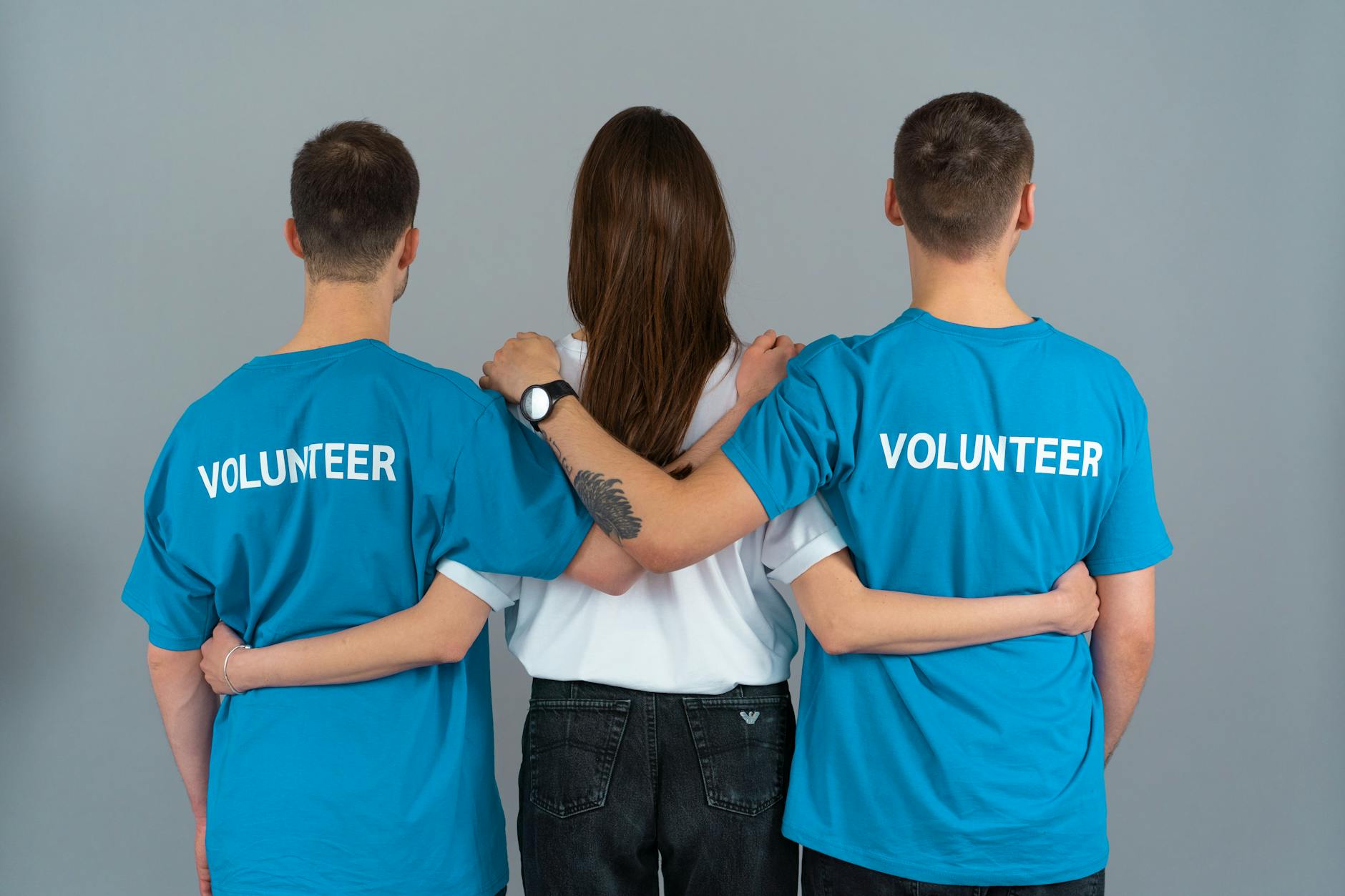 man in blue crew neck t shirt standing beside woman in white sleeveless shirt